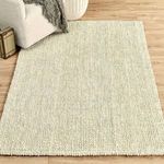 Rug styled in room setting with couch, wooden floor, and decorative elements