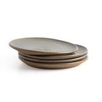 Rustic ceramic serveware group on white background includes pitcher, mugs, bowl, and stacked plates