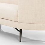 Close-up of sofa leg and stretcher connecting the legs in black stainless steel finish