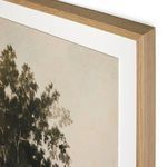 Close-up showing texture and sharp edge of paper within light wood frame