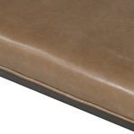 Close-up showing leather cushion edge tucked neatly around the frame corner