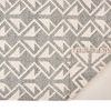 Backside of rug folded over revealing woven backing and fringe