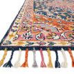 Close-up angled view showing colorful wool tassels and detailed rug texture