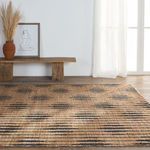 Rug laid flat under rustic bench with wall art and sheer curtains in background