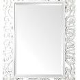 Rectangular wall mirror with ornate white scrollwork frame and beveled inner edge
