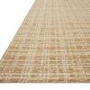 Angled side view showing rug's textured, raised pile and subtle grid pattern in neutral tones