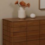 Gia dresser corner with decorative vase and dried flowers styling detail in soft warm lighting
