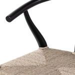 Close-up showing the joint of black teak armrest with seat weave tie