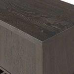Close-up angled view of top corner showing dark finished oak wood grain