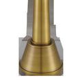 Close-up of brushed brass base showing smooth conical shape and matte finish