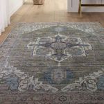 Rug with medallion pattern viewed from a lower angle highlighting the distressed abrashed colors