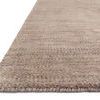 Low angled side view showing rug’s thickness and dense hand-loomed texture
