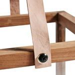 Close-up detail of natural leather strap attached to teak wood frame with brass screw fastener