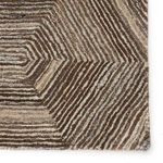 Close-up of rug’s detailed geometric pattern and pile texture in brown and gray shades