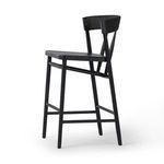 Close-up on the wood grain surface detailing of the black oak seat of the Buxton Drifted Oak Bar Stool