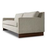 Angled view displaying sofa arm and cushions with cocoa brown wooden block base