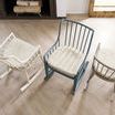 Overhead view focusing on seat cushions and back spindles of three differently finished Moorings rocking chairs