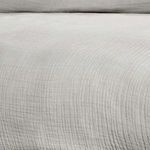 Close-up of gray linen duvet fabric highlighting breathable texture and subtle weave pattern