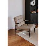 Verlaine chair in a living room corner with hardwood floor and adjacent black shelving unit