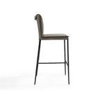 Side profile of Mayer Stool showing slim iron legs and padded seat with rolled leather backrest
