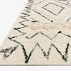 Leela Rug corner close-up showing wool pile texture and navy zigzag border from angled view