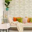 Wallpaper applied in a cozy living room with colorful pillows, textured rug, and decorative plant on side table