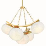 Duxbury Chandelier showing light glowing through seedy glass shades with brass metal detail and chains
