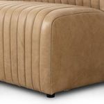 Close-up of banquette’s corner with smooth leather upholstery and curved seam detail
