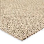 Close-up angle showing sisal fibers and raised diamond lattice texture on rug edge