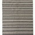 Black and white striped outdoor rug with geometric patterns, made from recycled materials