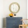 Ming Large 4-Drawer Dresser styled in bright room with gold sunburst mirror, yellow and orange flowers, and light wooden c...