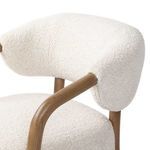 Focus on smooth curvature of armrest and textured upholstery showing wool-like fabric details