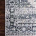 Close-up focus on the pattern and border details of Skye Silver/Grey Rug on a wood floor