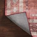 Rug corner lifted revealing textured gray non-slip backing material