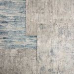 Multiple modern rug patterns in muted tones layered for comparison, featuring Heaston blue ivory abstract