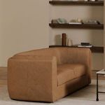Alora sofa styled in a modern living room with shelves and neutral decor