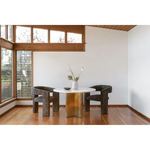 Two Elo Chairs flanking round marble dining table in bright room with large windows