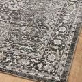 Close angled view highlighting patterned border details and subtle vintage motifs on a light wood floor