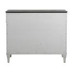 Back view of Caralina Chest showing flat plain sesame white panel with tapered legs
