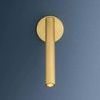 Sconce mounted on dark blue wall with LED light turned on showing subtle warm glow