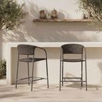 Two Zola Outdoor Bar Stools placed side-by-side against a stone bar with clay pottery decor