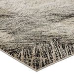 Close-up of rug corner showing tight weave and color gradient from taupe to black