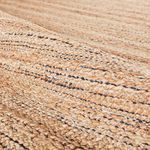 Detailed close-up on rug surface showing intertwined fibers and subtle navy threads