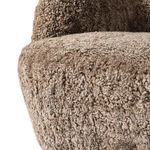 Close-up of textured upholstery on front edge and rounded side of chair