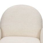 Close-up of the cream fabric texture on the rounded backrest of the Nicola chair