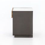 Side profile of nightstand showing smooth grey-lacquered panel and marble top edge