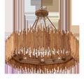 Front view of chandelier with visible warm glowing bulbs inside rattan shade