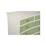 Close-up angled top view showing smooth white frame and textured green drawer fronts with brass pulls