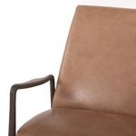 Side angle of olive green leather recliner with dark wood frame and extended footrest
