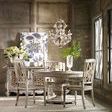 Chatelet round dining table with chairs in vintage styled dining room with chandelier and natural light from windows